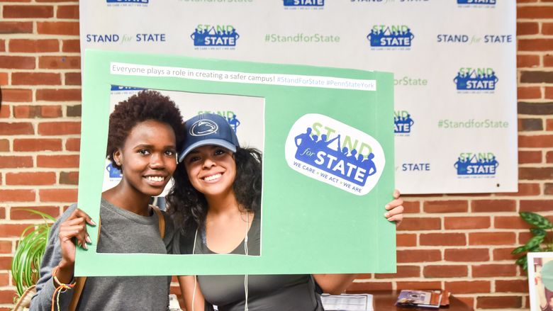 Students pose with Stand for State materials.