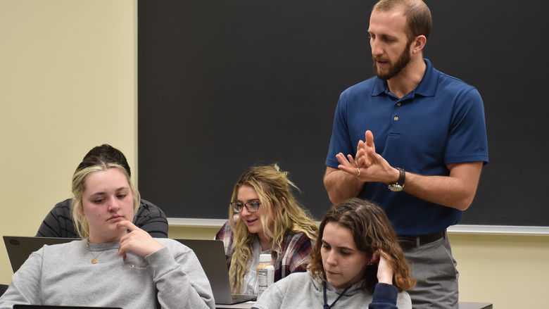 A professor and students in a classroom.