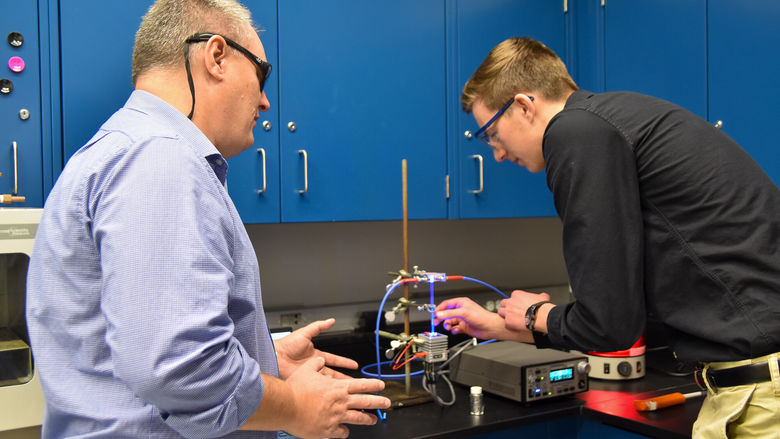 Logan Coomes (right) doing research with associate professor of chemistry Andy Landis (Left)