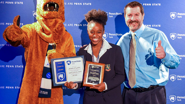 Nittany Lion character with Afican American female student and white male staff member