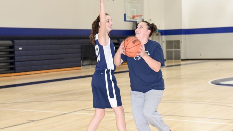Karra Thomason defends against her mother in a game of one-on-one.