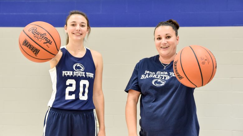 Karra and Amanda Thomason each palming a basketball.
