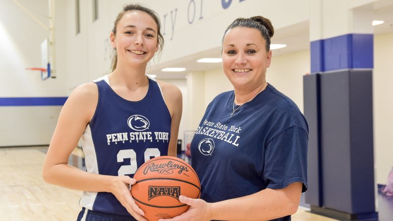 Karra and Amanda Thomason holding a basketball.