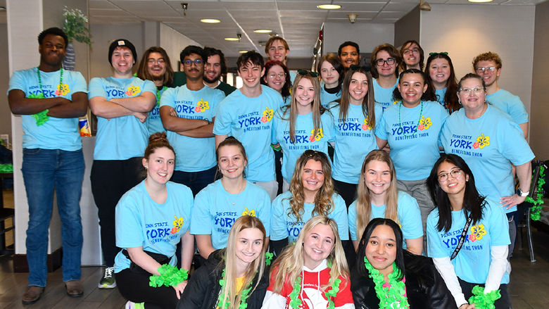 A diverse group of students in light blue shirts for THON