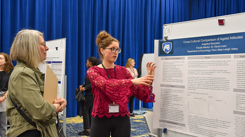 English student presenting her findings about the cross-cultural comparison of ageist attitudes at the undergraduate research fair on campus.