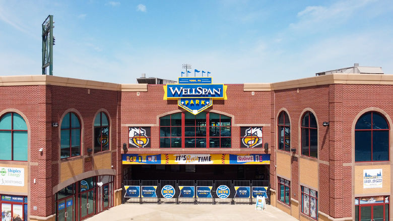 Brick front gates of a baseball park and sign WellSpan Park 