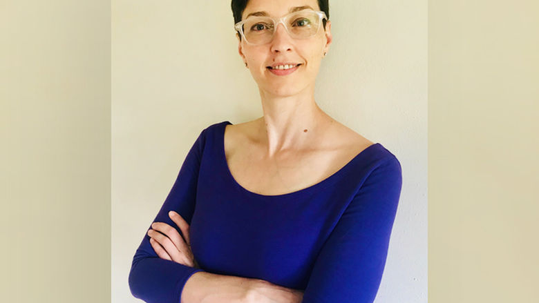 Woman with short dark hair and glasses