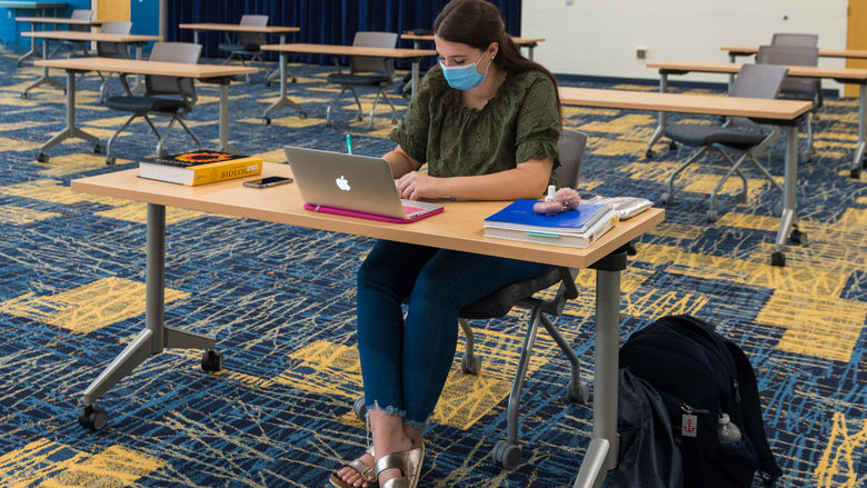 A student studying in the Conference Center Remote Learning Room.
