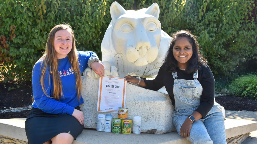 Two students at Nittany Lion Shrine