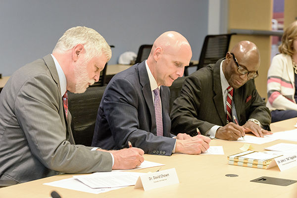 Drs. Chown, Sygielski, and Achampong sign articulation agreements. Drs. Chown, Sygielski, and Achampong sign articulation agreements.