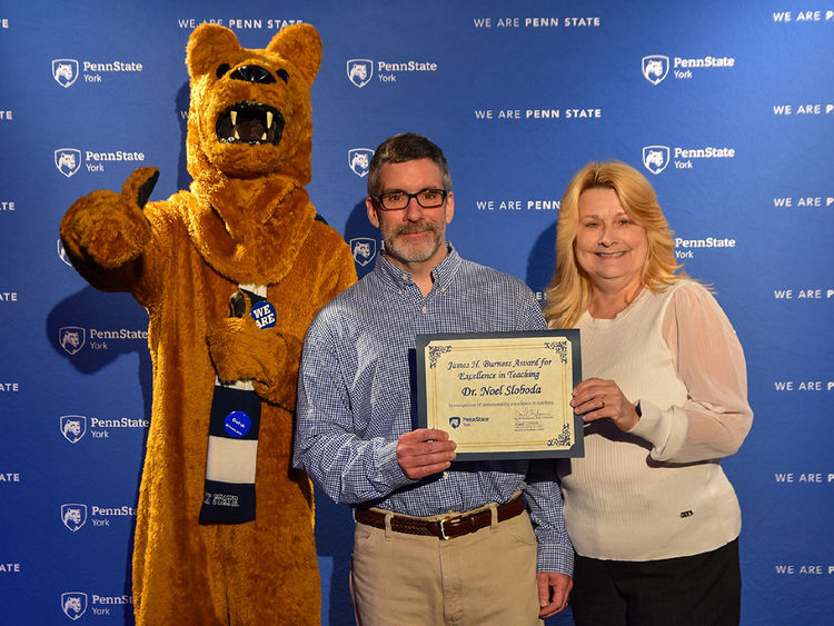 Nittany lion Characher with male and female faculty members