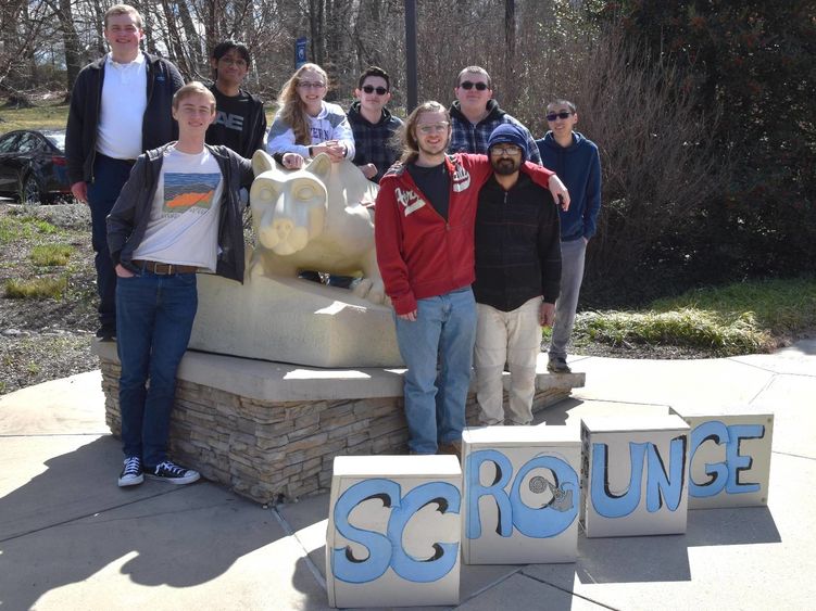 Students standing around the lion shrine. 