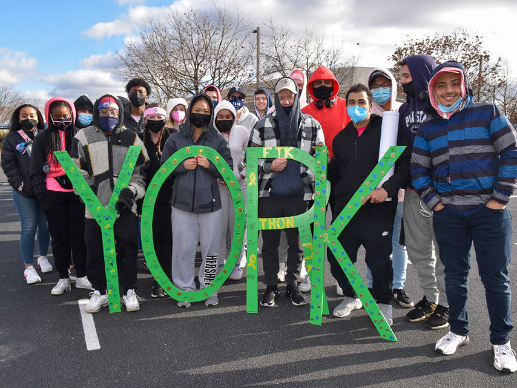 Group of students holding  green wooden letters spelling York 