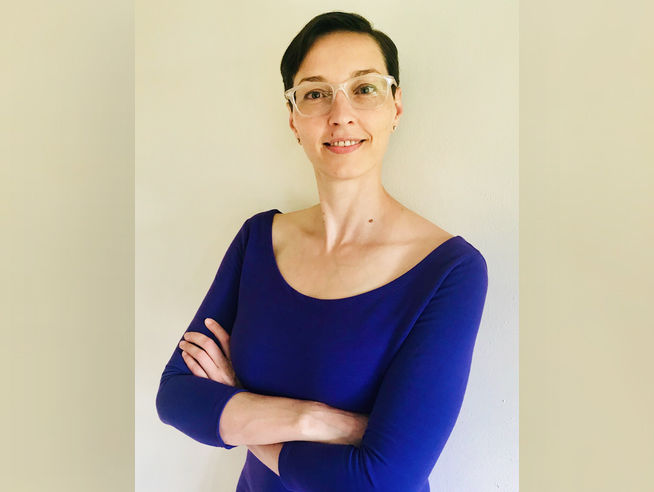 Woman with short dark hair and glasses